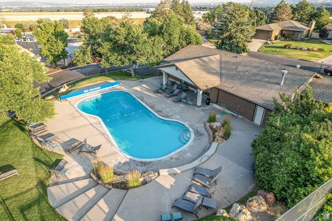 View of swimming pool with a fenced backyard and a patio area | Image 39