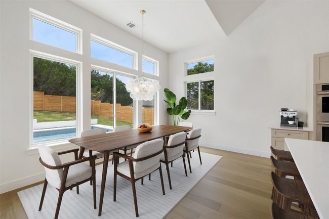 Dining space featuring a chandelier, baseboards, and light wood finished floors | Image 13