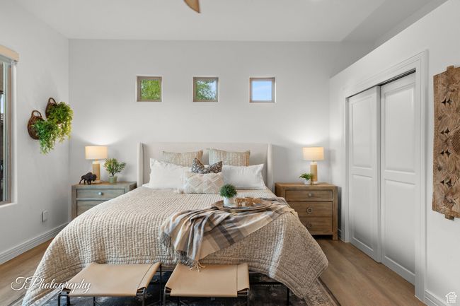 Bedroom featuring wood finished floors, baseboards, and a closet | Image 34