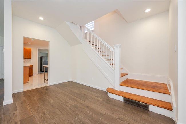 Stairway with recessed lighting, baseboards, visible vents, and wood finished floors | Image 10