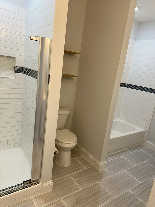 Full bathroom with an enclosed shower, seat, and tub | Image 20