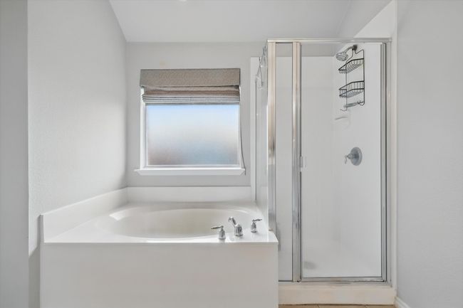 Full bath featuring a bath and a stall shower | Image 27