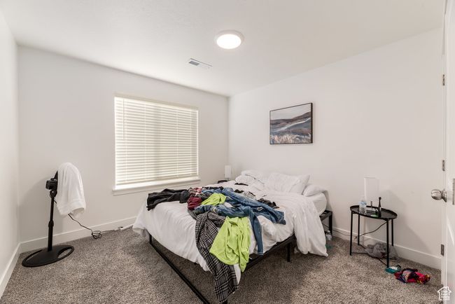 Carpeted bedroom with visible vents and baseboards | Image 18