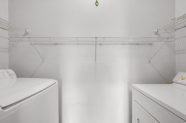 Off the kitchen is the utility area with the washer and dryer. | Image 11