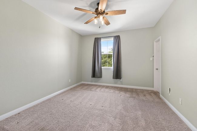 Empty room featuring a ceiling fan and carpet flooring | Image 33