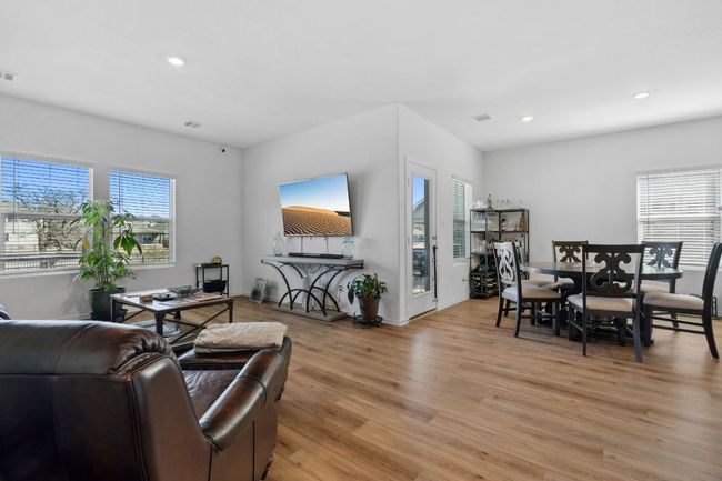 Living area with recessed lighting, visible vents, and light wood-style flooring | Image 5