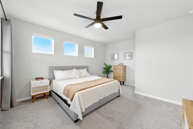 Spacious primary bedroom with ceiling fan | Image 13