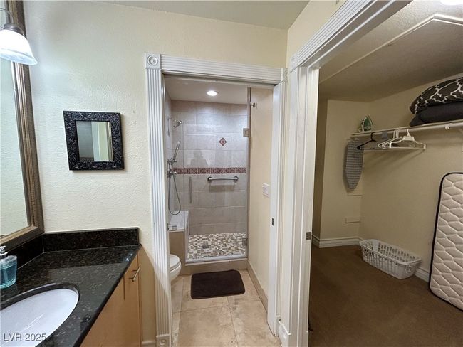 Bathroom featuring a shower stall, vanity, and tile patterned flooring | Image 36