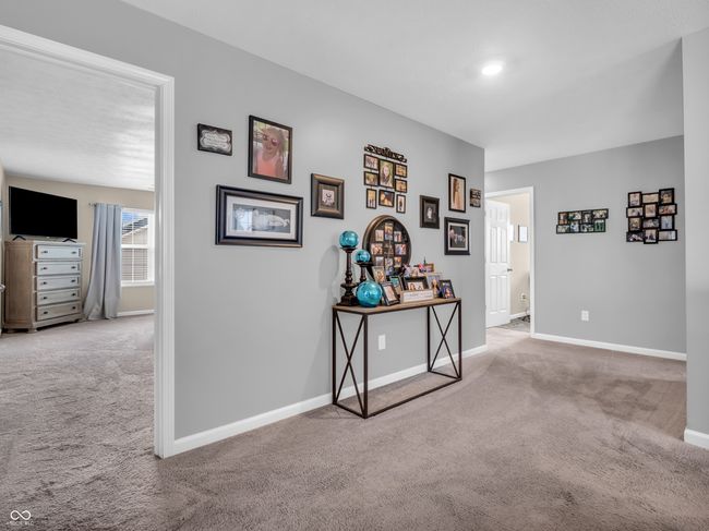 corridor featuring carpet flooring and baseboards | Image 23