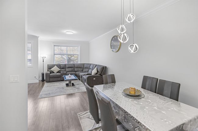 Dining area with ornamental molding and dark wood finished floors | Image 5