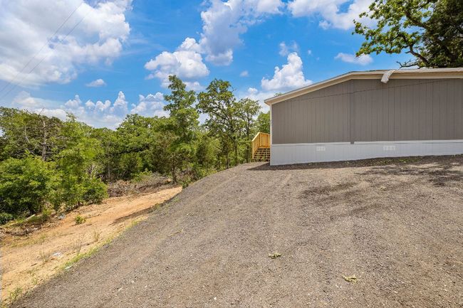 View of home's exterior featuring crawl space | Image 5