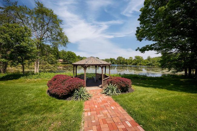 View of green lawn with a gazebo and a water view | Image 33