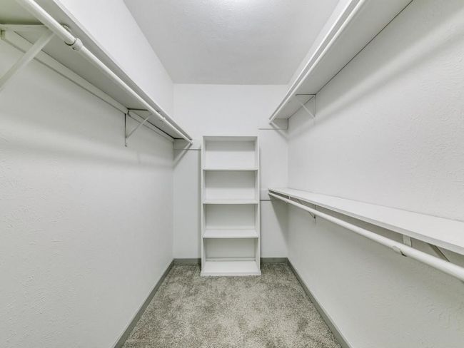 Walk in closet featuring light carpet | Image 12