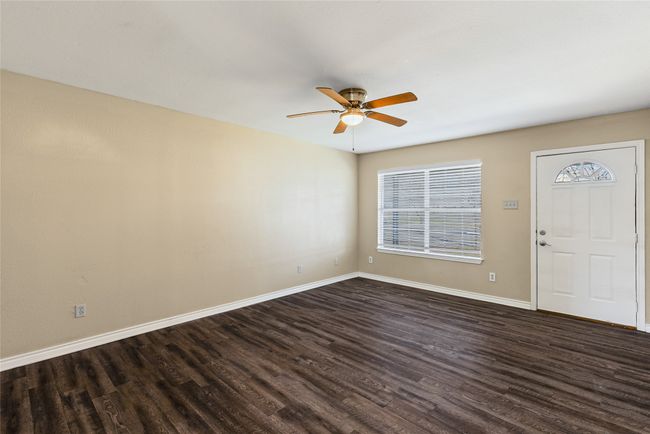 Entrance foyer featuring dark wood-type flooring, a ceiling fan, and baseboards | Image 28