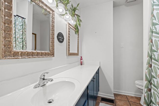 Full bathroom with toilet, vanity, tile patterned floors, and baseboards | Image 14