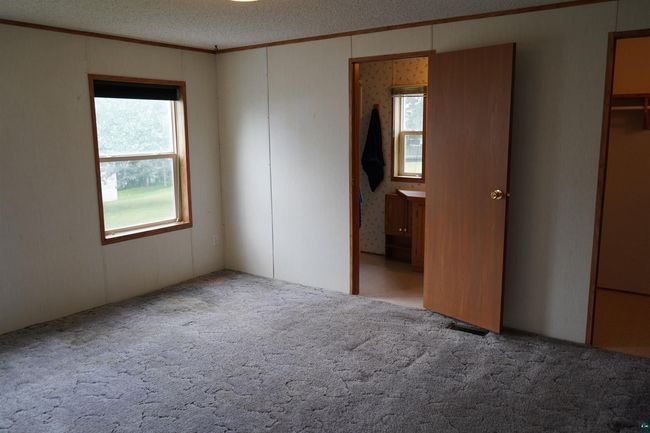 Unfurnished bedroom featuring crown molding, carpet, and a textured ceiling | Image 21