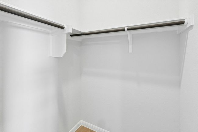 Spacious closet with wood finished floors | Image 20