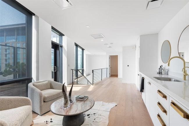 Hall featuring a sink, an upstairs landing, and light wood-type flooring | Image 34