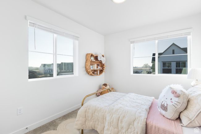 Carpeted bedroom featuring multiple windows | Image 27