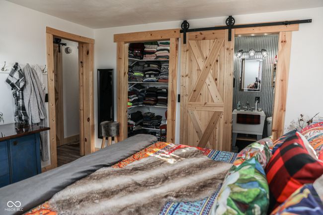 bedroom with a barn door | Image 13