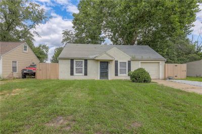 View of front of property with a front yard and a garage | Image 1