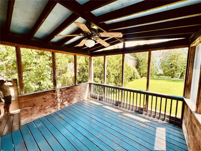 Unfurnished sunroom with ceiling fan and lofted ceiling | Image 19