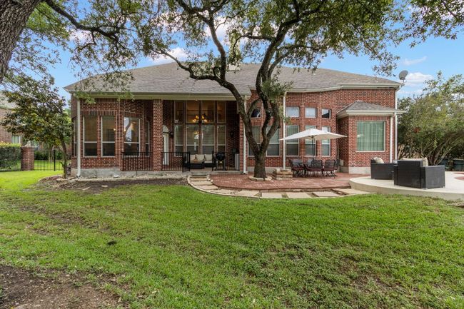 Rear view of property with brick siding, a patio area, and roof with shingles | Image 37