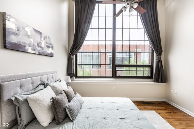 bedroom with wood finished floors and baseboards | Image 21