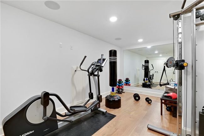 Exercise room with recessed lighting, wood finished floors, and baseboards | Image 56