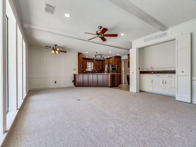 Family room has space for bar stools and a dining table. | Image 13