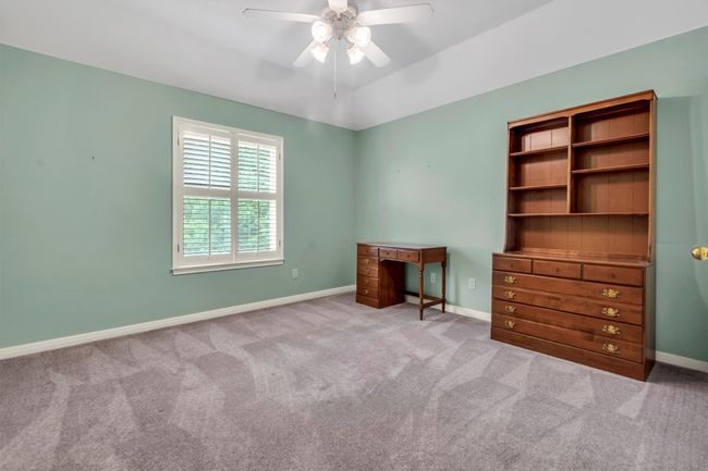 Unfurnished bedroom featuring baseboards, a ceiling fan, and carpet flooring | Image 25