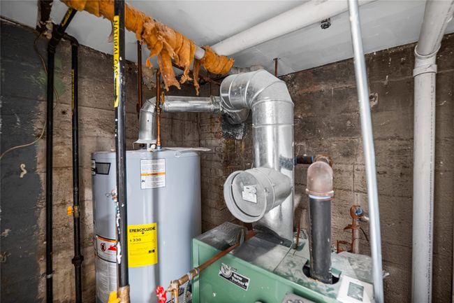 Utilities featuring gas water heater | Image 21