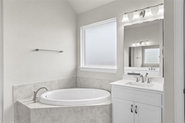 Full bath with vanity, a bath, and lofted ceiling | Image 14