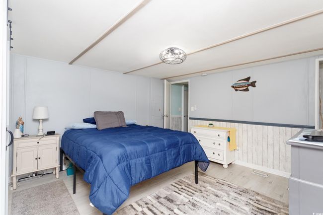 Bedroom with light wood-style flooring | Image 19