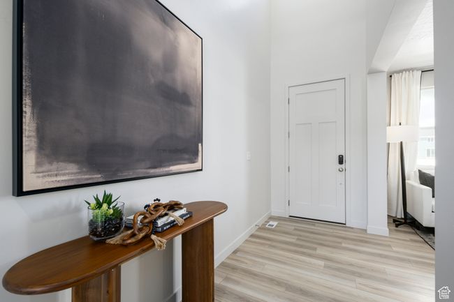 Entryway featuring light wood-type flooring and baseboards | Image 9