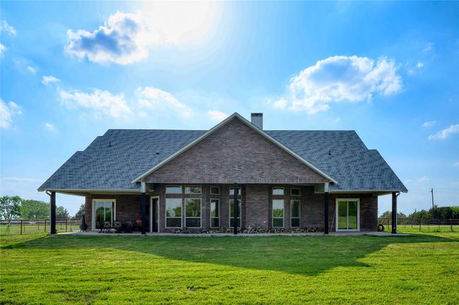 Rear view of house with a lawn, fence, and a patio | Image 27