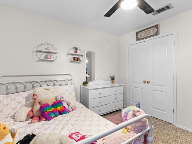 Carpeted bedroom featuring a ceiling fan | Image 23