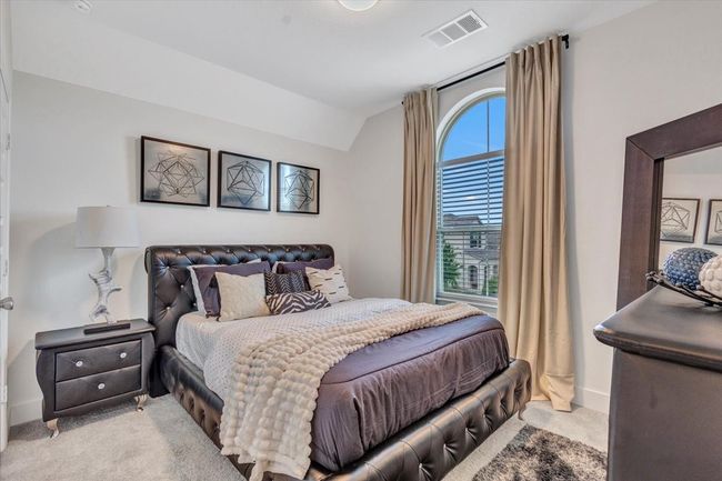 Bedroom featuring carpet floors, vaulted ceiling, and a big window to view the outside. | Image 27