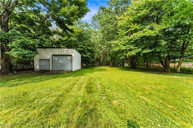 View of grassy yard featuring an outbuilding | Image 33