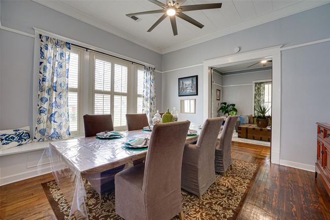 Dining space with ceiling fan, ornamental molding, dark wood-style flooring, and plenty of natural light | Image 10