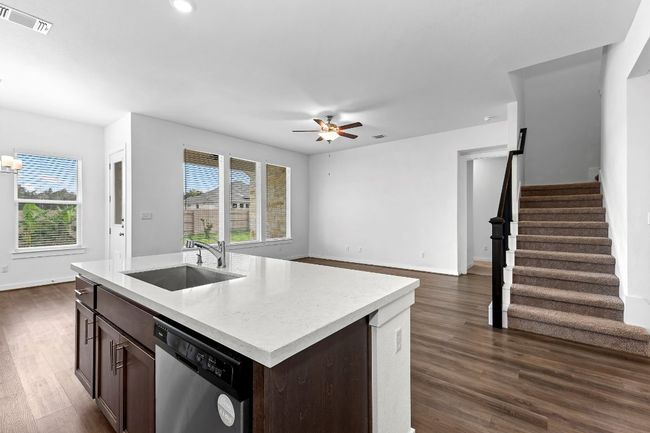 Kitchen with a sink, dishwasher, a ceiling fan, light countertops, and plenty of natural light | Image 14