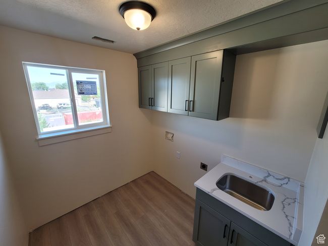Huge Laundry Room with full cabinets, a sink w/drying rod above, and even a great view! | Image 11