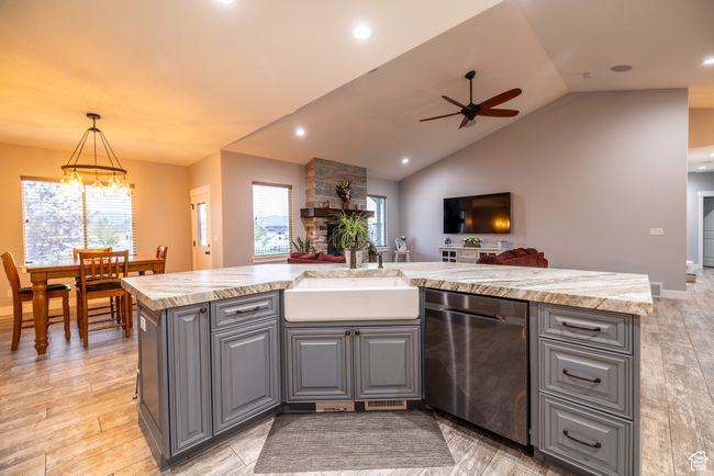 Kitchen featuring dishwasher, gray cabinets, a ceiling fan, open floor plan, and lofted ceiling | Image 21