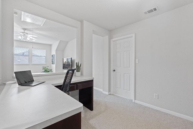 Home office with attic access, ceiling fan, light carpet, and baseboards | Image 15