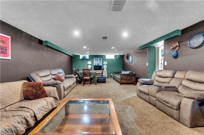 Living room with carpet floors, a textured ceiling, and recessed lighting | Image 29
