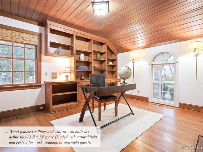 Wood-paneled ceilings and wall-to-wall built-ins define this 13.5' x 13' space flooded with natural light and perfect for work, reading, or overnight guests. | Image 24