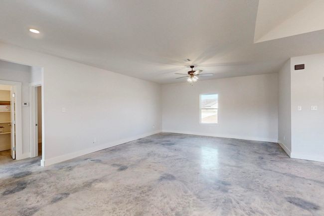 Empty room with baseboards, recessed lighting, a ceiling fan, visible vents, and concrete flooring | Image 10