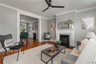 Living room featuring hardwood / wood-style floors, ceiling fan, and ornamental molding | Image 2