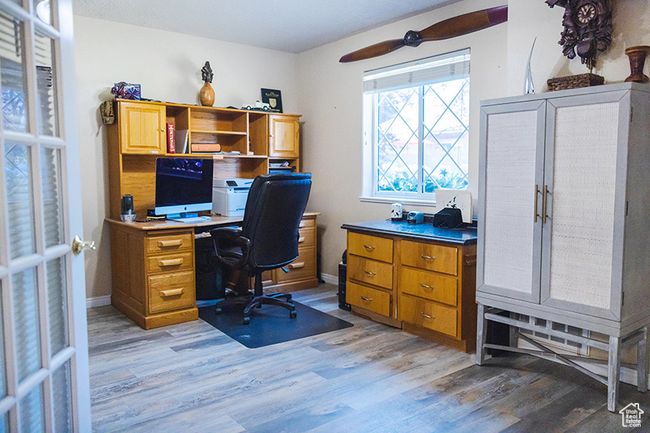 Home office with light wood-style floors and ceiling fan | Image 20