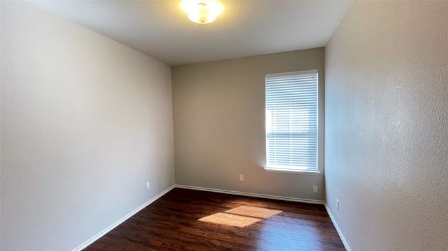 Spare room featuring dark wood finished floors and a textured wall | Image 23